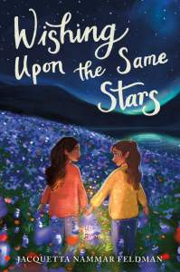 In foreground, two girls hold hands while walking through a field of flowers. In the background is a river and hills and a night sky filled with stars. The text "Wishing Upon the Same Stars" is at the top of the image.